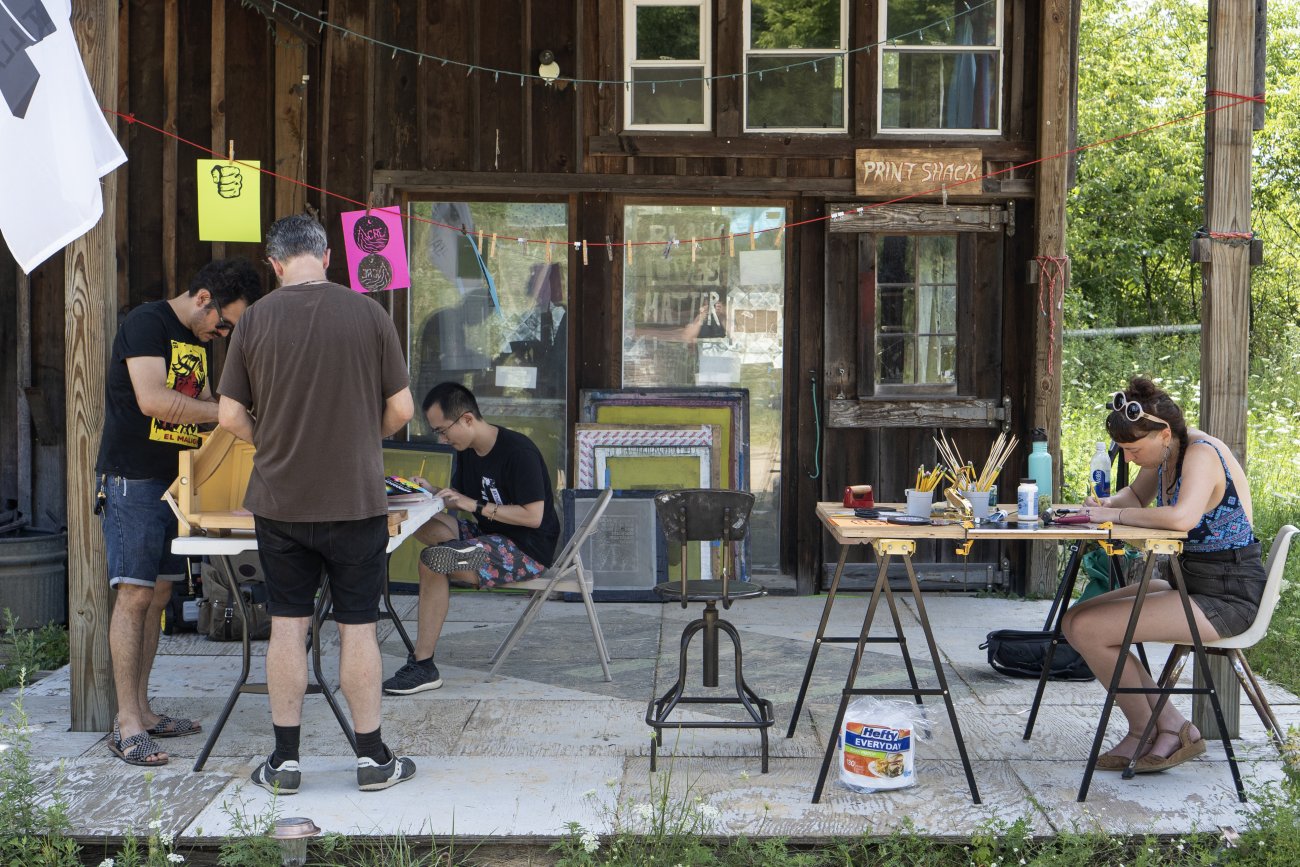 Artists working in front of the screenprinting studio